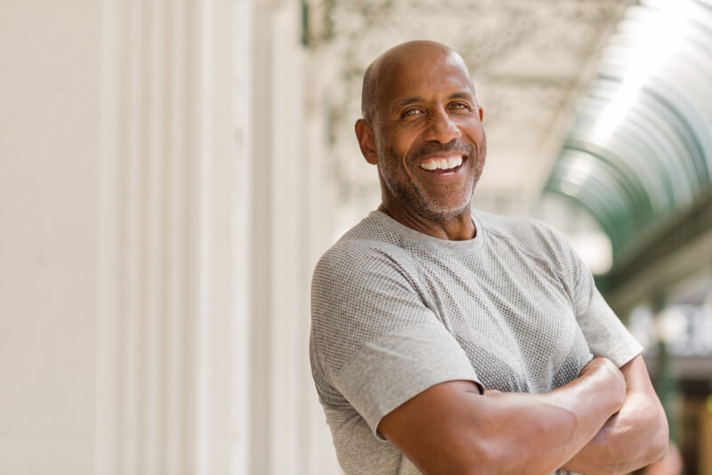 Mature African American man smiling outside